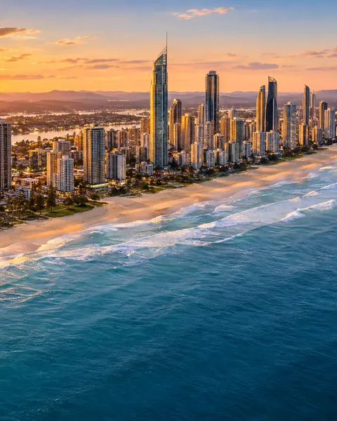 Aerial view of the Gold Coast skyline and surf beach at sunset